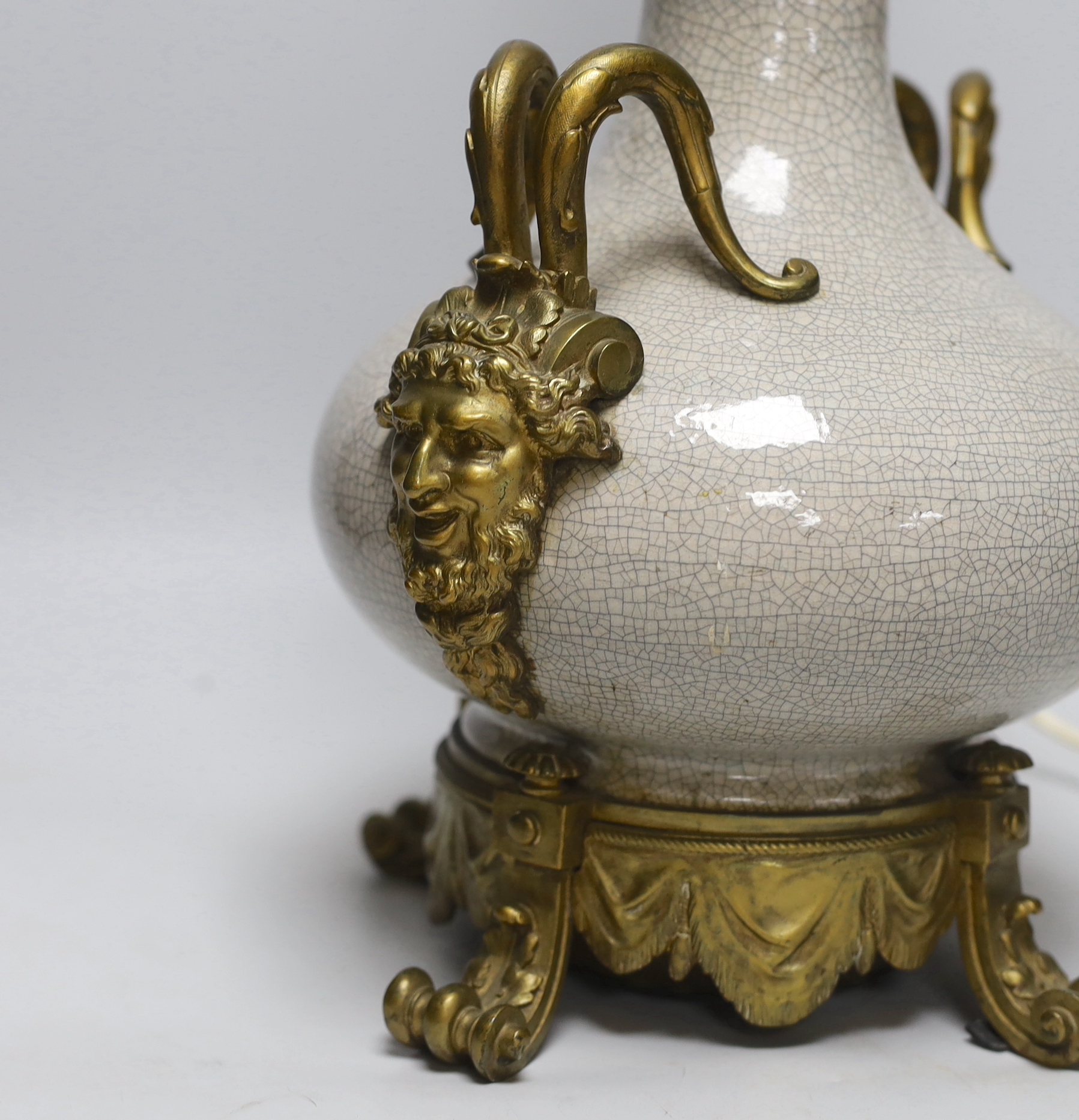 A crackle-glaze lamp with gilt mask design twin handles, 48cm high